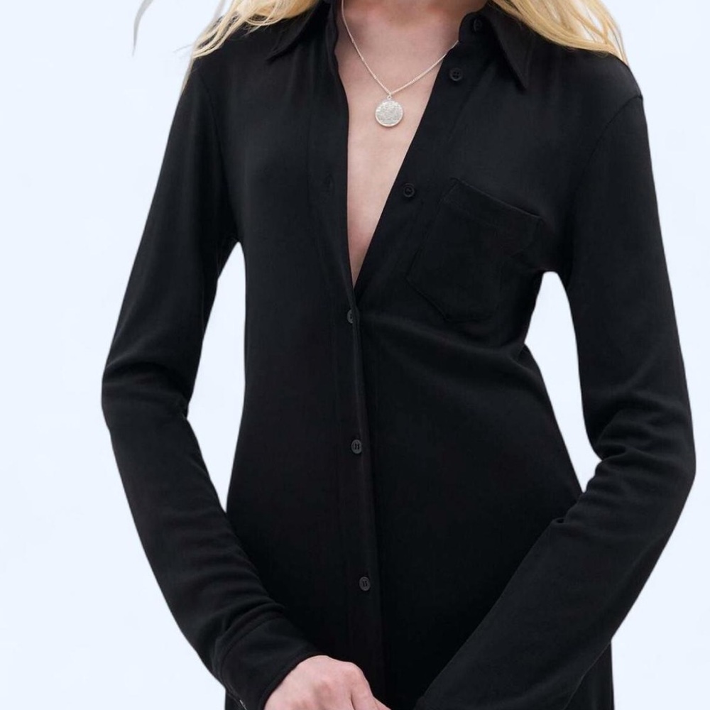 Black thin stretchy long sleeve button up top with front side pocket